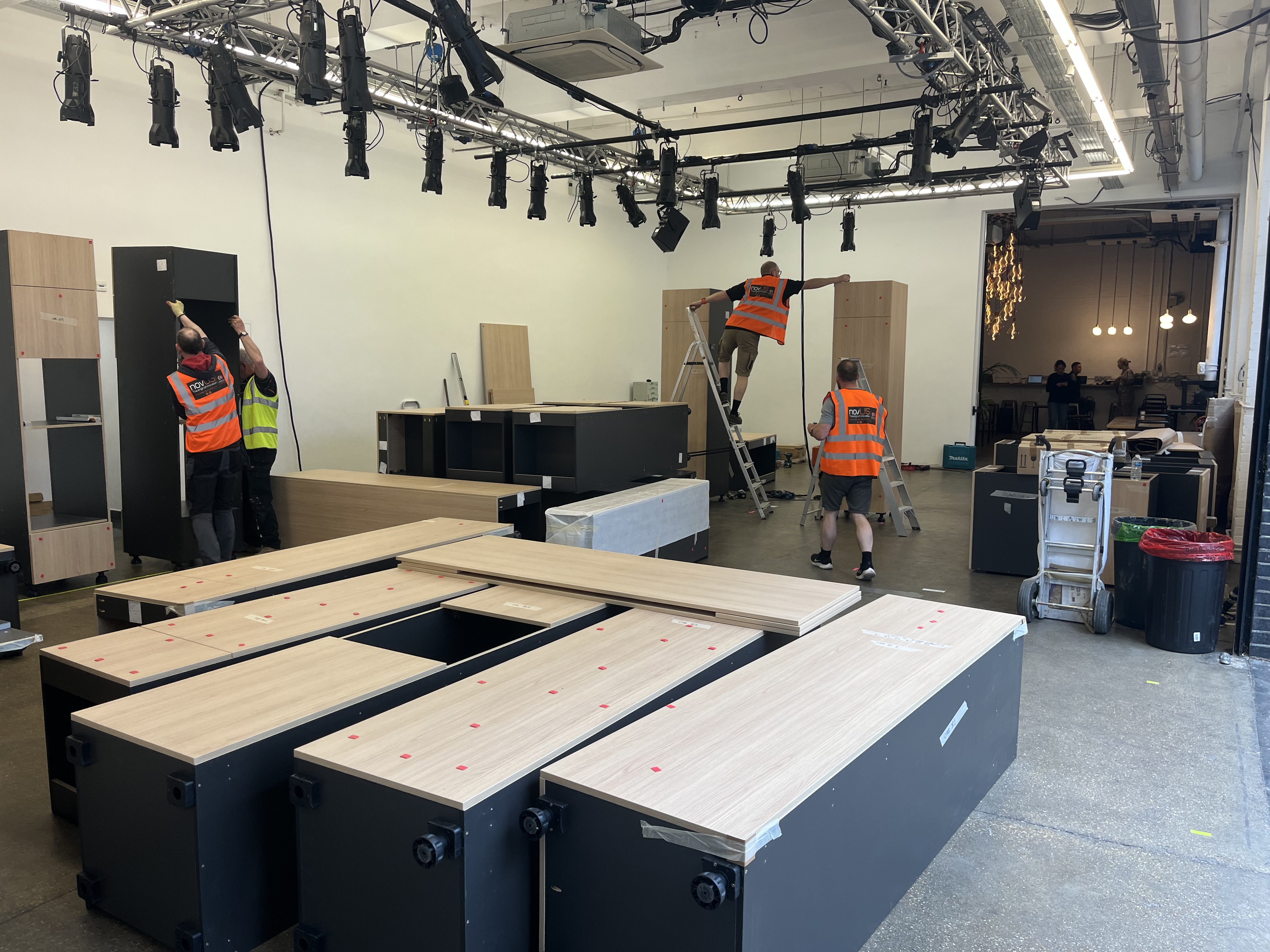 Fisher & Paykel exhibition stand build-up with workers in hi-vis